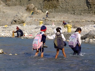 Nepalese Children crossing the river Sai
